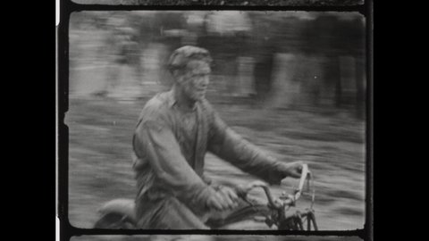 1940s Lansing, MI. Motorcyclist on Harley-Davidson Race off road at  Jack Pine Endurance Run. Muddy Bikers guide Motorbikes through Extreme Terrain. Motorcycles Collide 4K Overscan of 16mm Film Print 