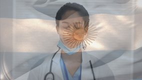 Animation of flag of argentina with gloved female doctor putting on face mask. healthcare and protection during coronavirus covid 19 pandemic, digitally generated video.