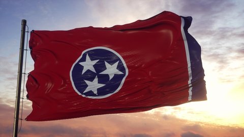 Flag of Tennessee waving in the wind against deep beautiful sky at sunset