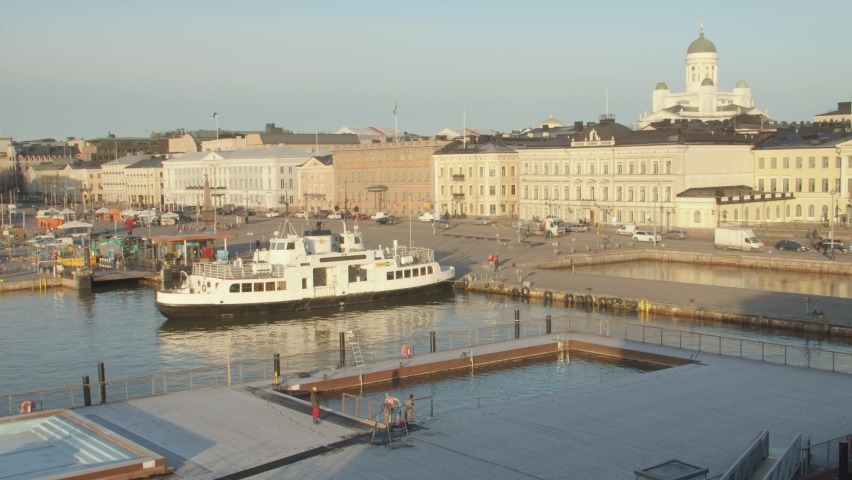 Sunrise warm morning light hitting buildings and harbour in Helsinki, Finland