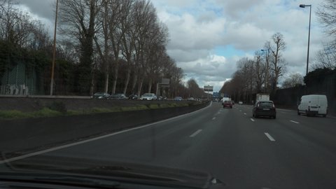 Windshield View. Driving Car Moving Along Highway in Paris Suburbs. France Europe. 2x Slow motion 60 fps