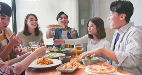 Group of asian cheerful friends dine together and they talk happily in the restaurant