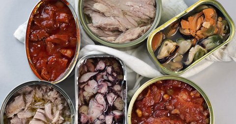 Various canned fish and seafood in aluminum cans.