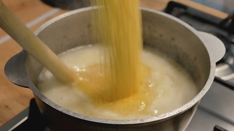 corn porridge boils on a stove. hutsul traditional dish. dietic meals