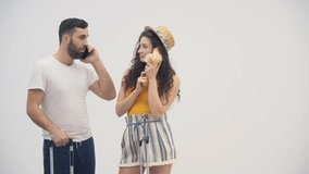 4k video of beautiful couple playing like kids using seashell as a phone.