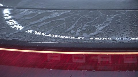 Krasnodar. Russia - January 29 2021: Washing a gray Porsche Taycan car in the garage.