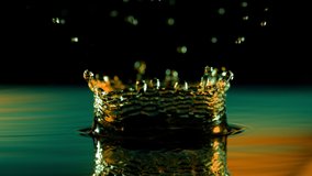 Super slow motion of splashing water crown illuminated by neon lights. Filmed on very high speed camera, 1000 fps. - Powered by Shutterstock - Get 15% off with code: PIKWIZARD15