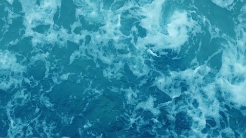 Beautiful sea waves. Top view waves in a blue ocean. Water surface texture