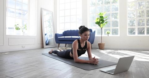 Healthy lifestyle ideas, Women are taking a virtual fitness class with a group of people at home in a video conference, Online yoga fitness instructor via video call on laptop.
