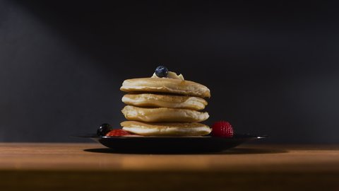 A delicious stack of pancakes with strawberries, blueberries and raspberries covered with a mouthwatering layer of syrup. Perfect for pancake day, social posts, food vlogs and more. In stunning 4k.