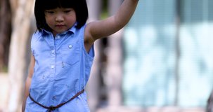 4K Video Slow motion Asian mom and little daughter hold hand walking in the park. Concept for family relationship and relaxing time.