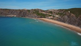 Aerial video shooting. Arrifana beach scenery, Aljezur, Portugal, Algarve on a sunny day. An ideal place for tourists, surfing, fishing.
