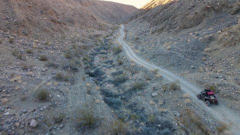 Cinematic aerial shot of ATV buggy driving in Death Valley, California