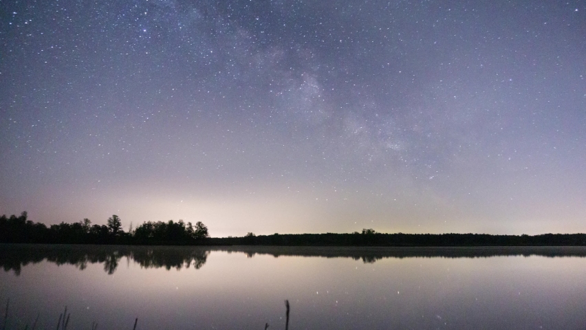 Milky-way and rising moon above a lake 