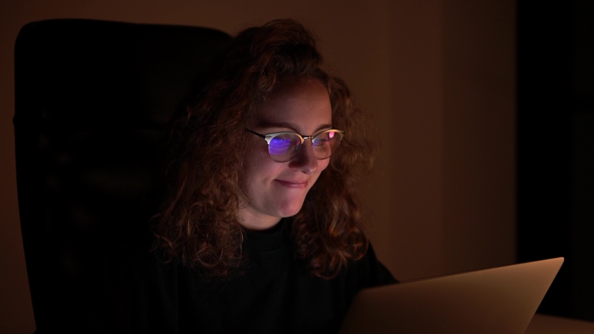 4K, Young woman making denial gestures as she surfs on her computer at night. She is in the dark in the room or office. | Shutterstock HD Video #1066912195