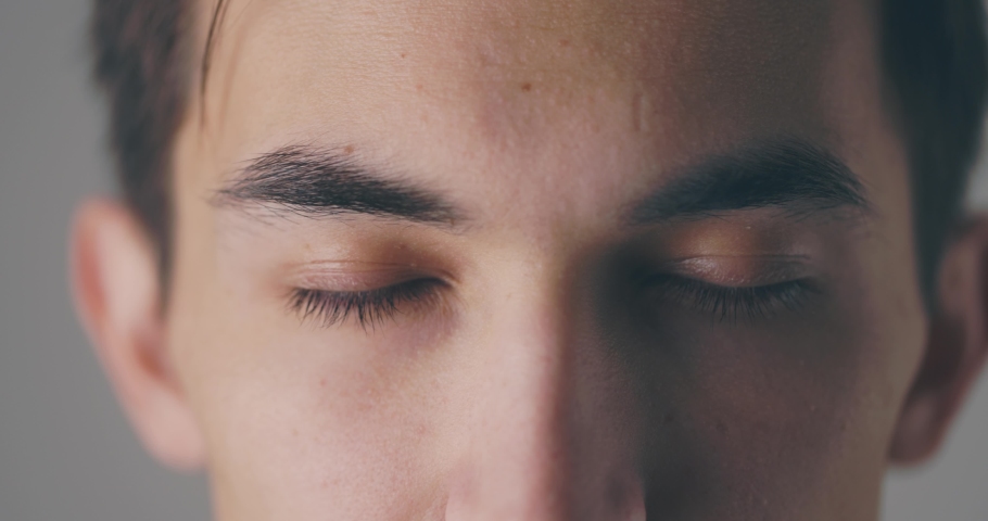 Close up portrait of caucasian male's eyes opening before smiling to camera, in slow motion Royalty-Free Stock Footage #1066918360