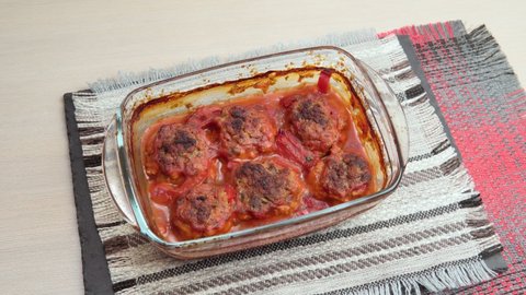 Meatballs baked in form in the oven with tomato paste, tomatoes, onions and spices.