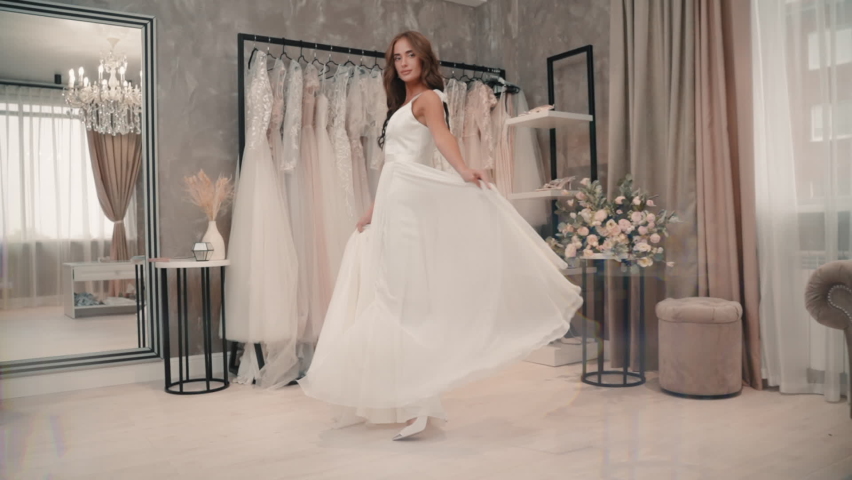 Model wear wedding dress and show new fashion collection of bridal gown. Young woman do fitting | Shutterstock HD Video #1066927027