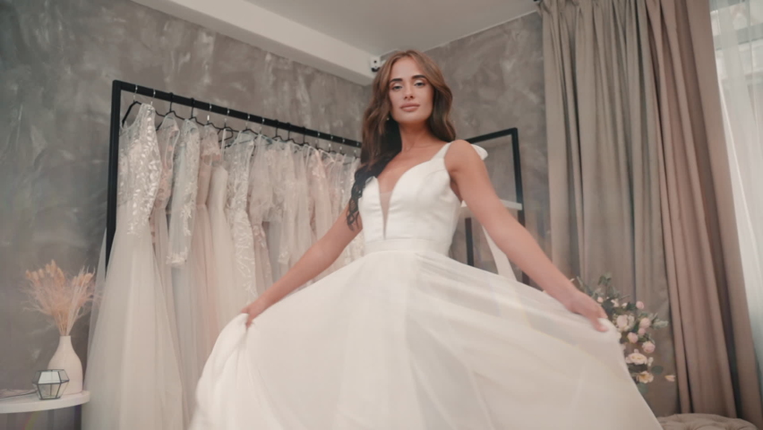 Bride spinning in wedding dress in salon store. Luxury elegant woman model pose in charming white | Shutterstock HD Video #1066927030