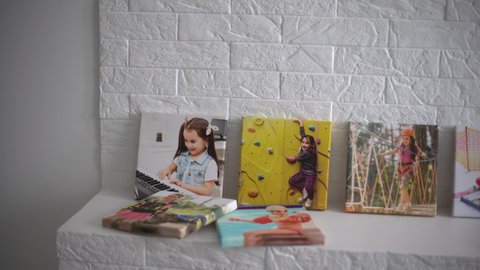 exhibition of photos, photocanvases, active little girl.