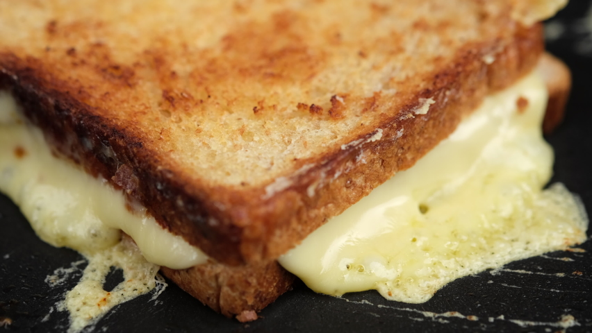 Hot double sandwich with cheese on pan. grilled cheese sandwich close up | Shutterstock HD Video #1066943977