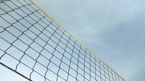 Looking up beach volleyball net, clear sky background