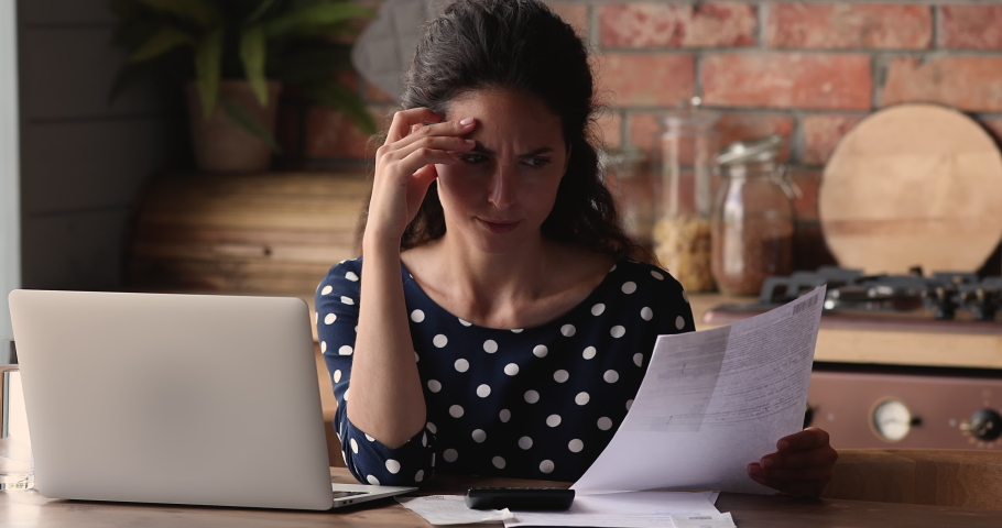 Young frustrated woman sit with laptop in kitchen at home feels worried checking bills due high taxes, unpaid invoice need to pay. Concept of financial problem, lack of money, overdue and debt concept Royalty-Free Stock Footage #1066944850