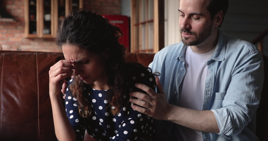 After quarrel husband comforts his wife, apologizes for intemperance hard character traits or unreasonable jealousy. Silent annoyed woman listens to spouse apology. Quarrel, relations crisis concept