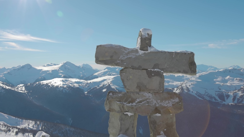 Whistler, British Columbia, Canada. Beautiful View of Statue on top of Blackcomb Mountain with the Canadian Snow Covered Landscape in background during a cloudy and vibrant winter day. Royalty-Free Stock Footage #1066952212