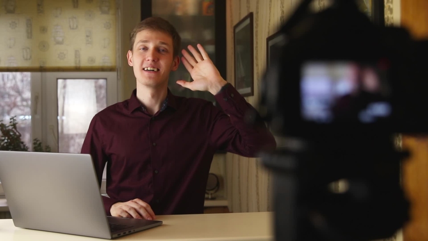 Famous young influencer excited while talking with the camera. Recording new episode for followers. Creative content creator.