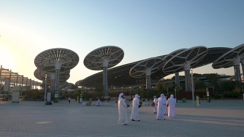 Dubai, United Arab Emirates - February 4, 2020: Emirati entertainers in front of Terra Sustainability Pavilion at the EXPO 2020 at sunset built for EXPO 2020 scheduled to be held in 2021 in the UAE