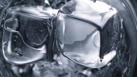 Super Slow Motion Detail Shot of Ice Cubes Falling into Glass With Alcohol Liquid at 1000 fps. - Powered by Shutterstock - Get 15% off with code: PIKWIZARD15