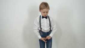 Joyful little boy. Dressed in jeans and a shirt on a white background. Emotion Video Series