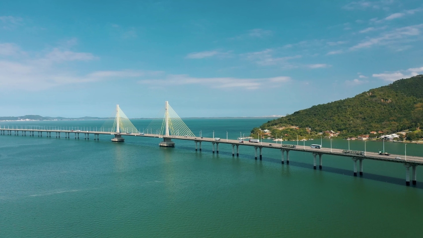 Panoramic aerial shot along bridge above tropical ocean, located in Laguna, Santa Catarina, Brazil