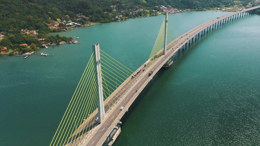 Amazing establishing aerial shot along Anita Garibaldi bridge above the ocean, located in Laguna, Santa Catarina, Brazil