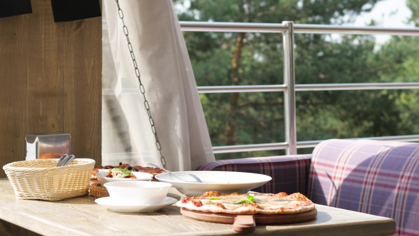 woman having lunch in a summer restaurant. young attractive woman in a cafe eating salad. business lunch