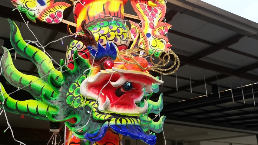 close shot footage of dragon head figure on the joss stick pole.
