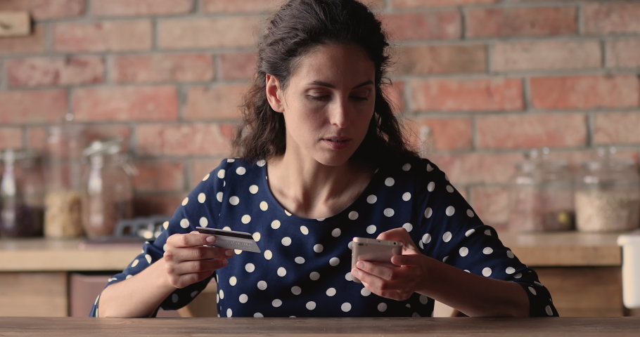 Woman hold cellphone and credit card experiencing financial problem while makes transaction, feels irritated due lack of money, debit card blocking, internet fraud and scam, empty bank account concept Royalty-Free Stock Footage #1066988839