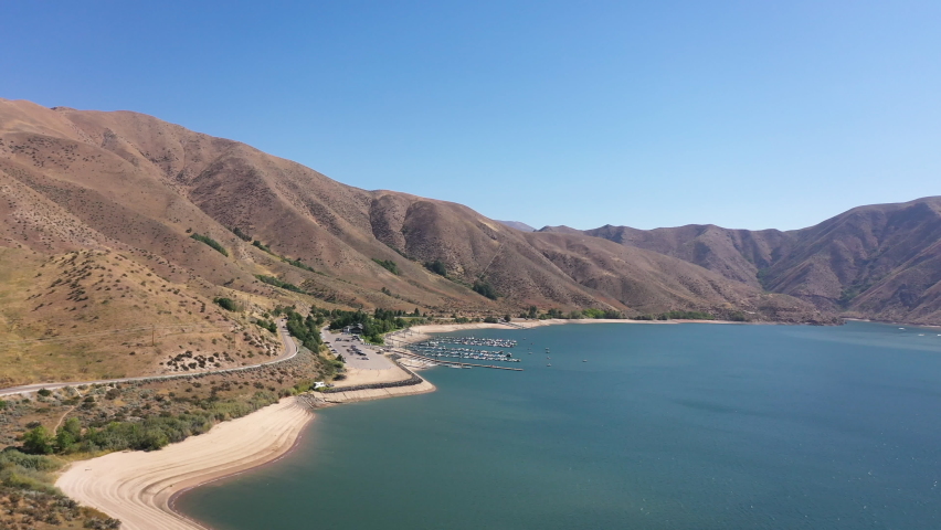 Drone gliding over Lucky Peak State Park Spring Shores Marina with boats, recreational and foothills 