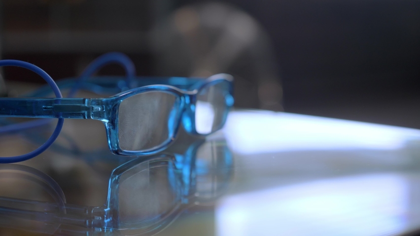 A close up look at the blue glasses lying on the table