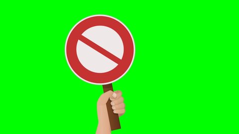 A hand holds up a prohibition sign, and then lowers it on green background