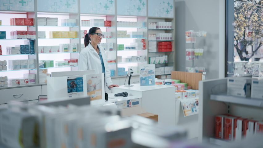 Pharmacy Drugstore Checkout Cashier Counter: Pharmacist and a Customer Using NFC Smartphone with Contactless Payment Terminal to Buy Medicine Package, Drugs Health Care Products. | Shutterstock HD Video #1067000170