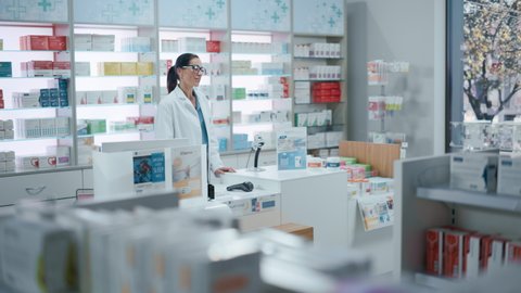 Pharmacy Drugstore Checkout Cashier Counter: Pharmacist and a Customer Using NFC Smartphone with Contactless Payment Terminal to Buy Medicine Package, Drugs Health Care Products.