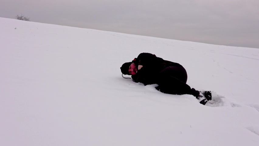 Hiker, tired, alone, fallen in the snow, trembling. Hypothermia Royalty-Free Stock Footage #1067014048