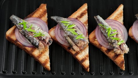 toast with sardines on grill, top view