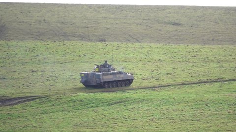 action shot of a british army Warrior FV510 light infantry fighting vehicle in action on a military exercise