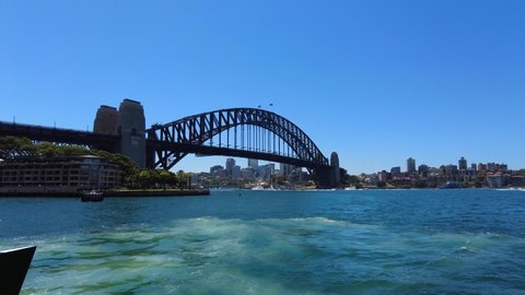 Tracking shot towards Sydney Harbour Bridge on a sunny day