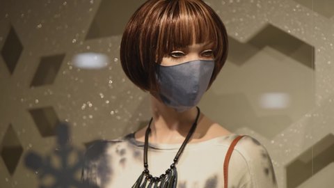 a manikin comes into focus showing winter fashion and wearing a mask.