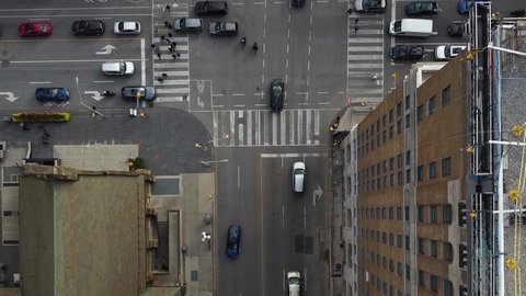 Cropped Aerial top down busy city street intersection traffic with pedestrians and bikes