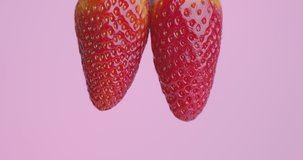 Strawberry jam drops flows down fom berries on pink studio background with copy space, sweet dessert with vitamins